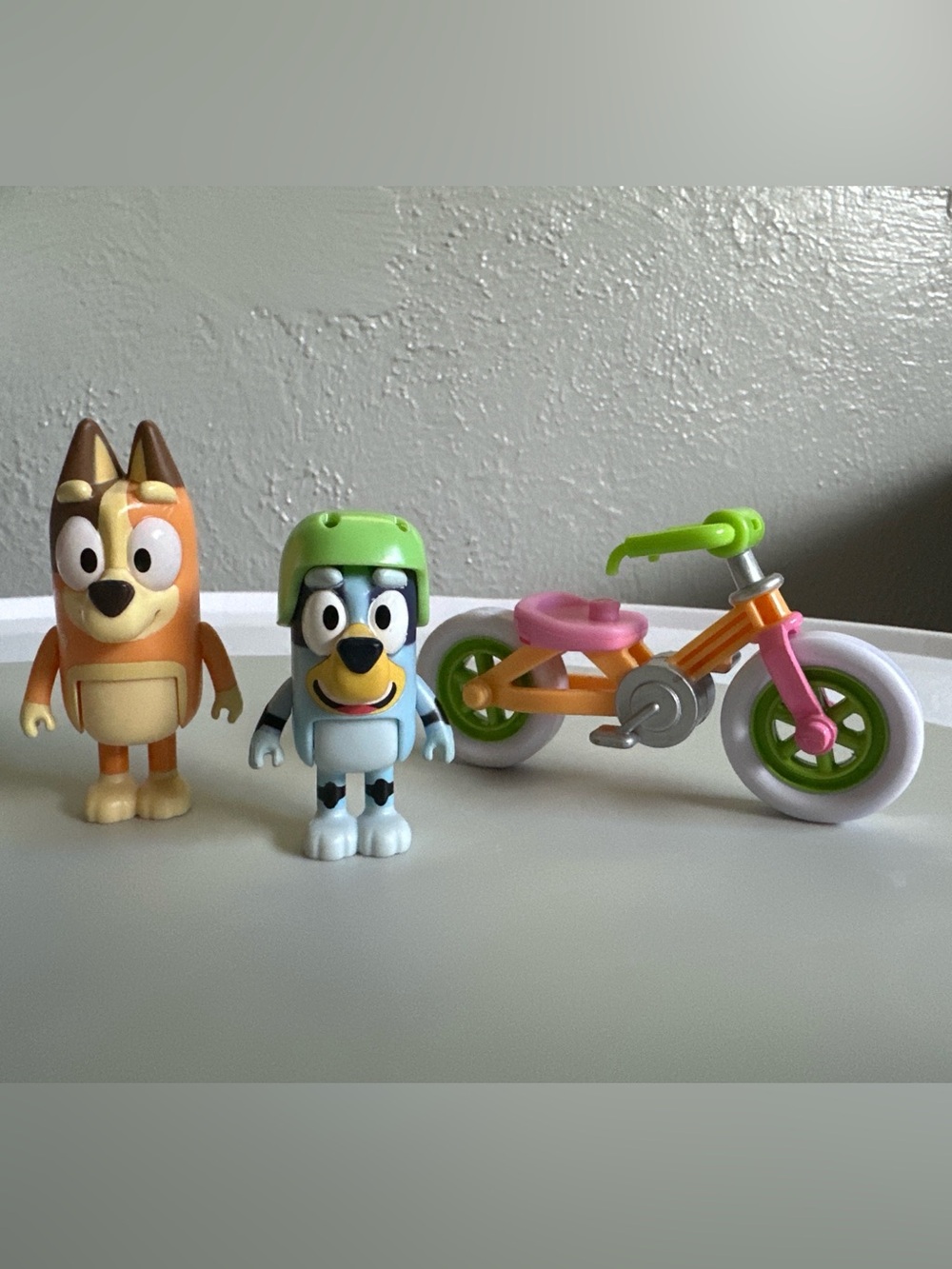 Bluey and Chilli figures with bike